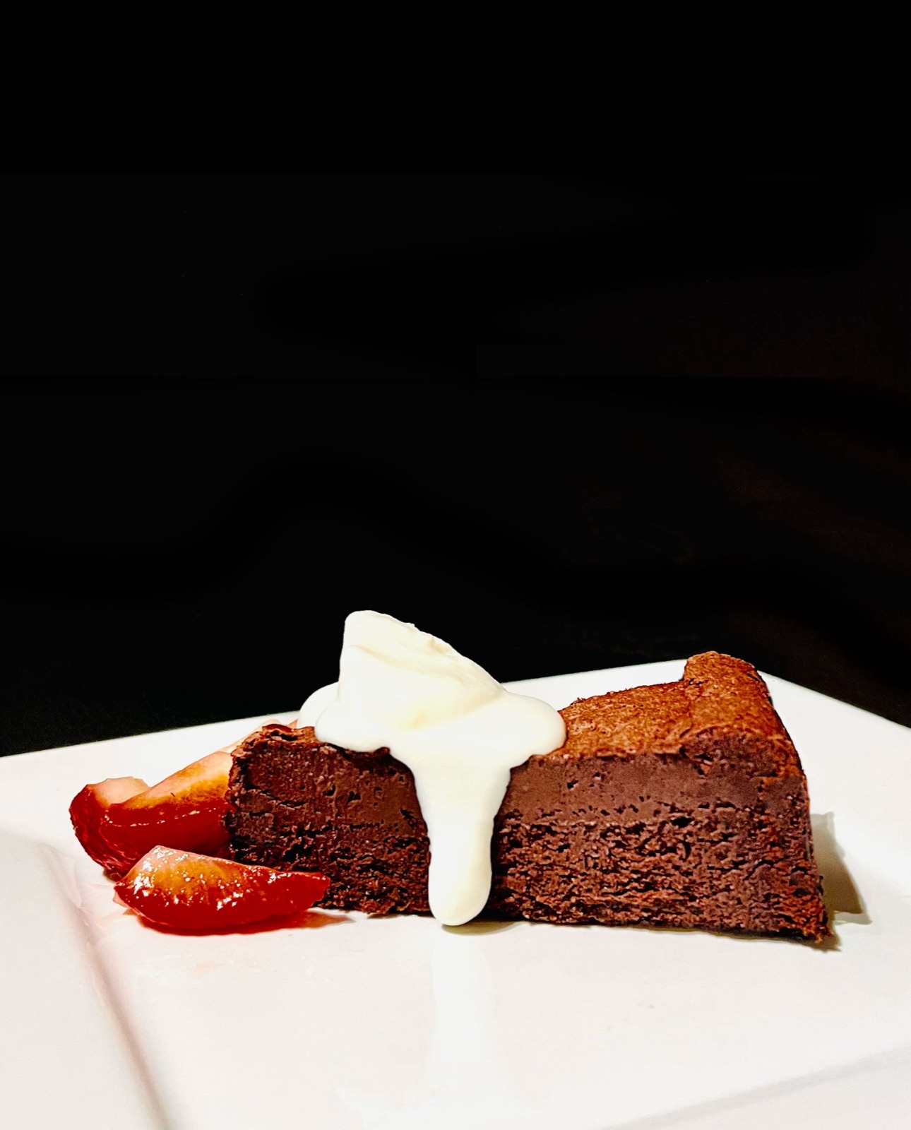 Flourless chocolate cake with cream and strawberries